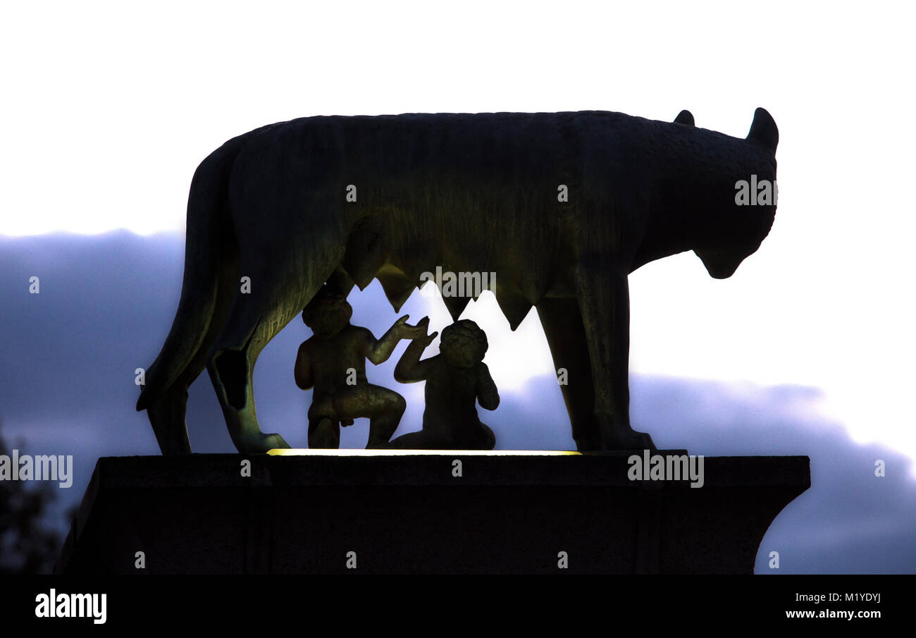 Bronze sculpture of the she-wolf with Romulus and Remus. Silhouette Back view Stock Photo