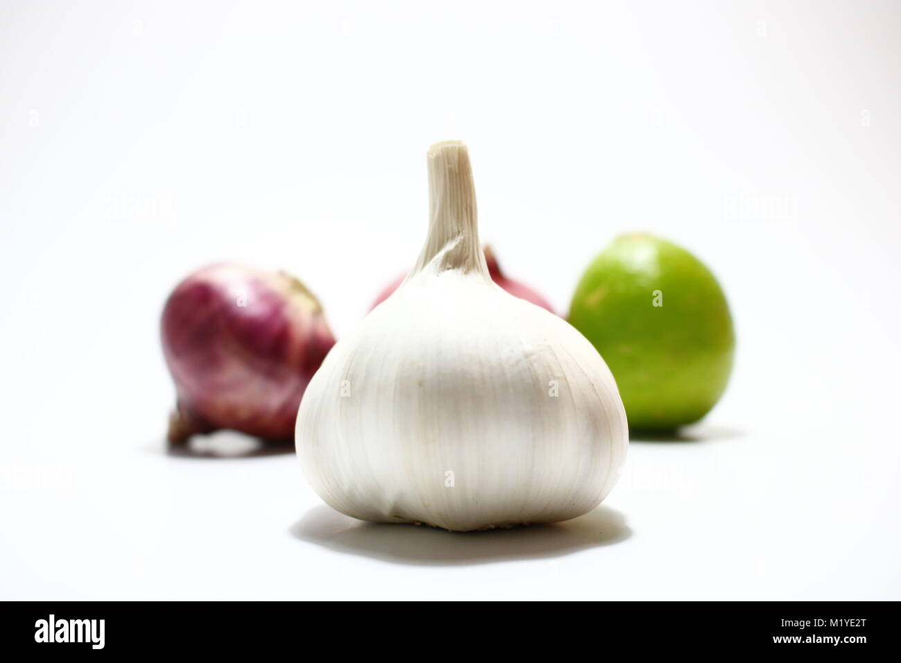 Garlic and onion and lime in white background Stock Photo Alamy