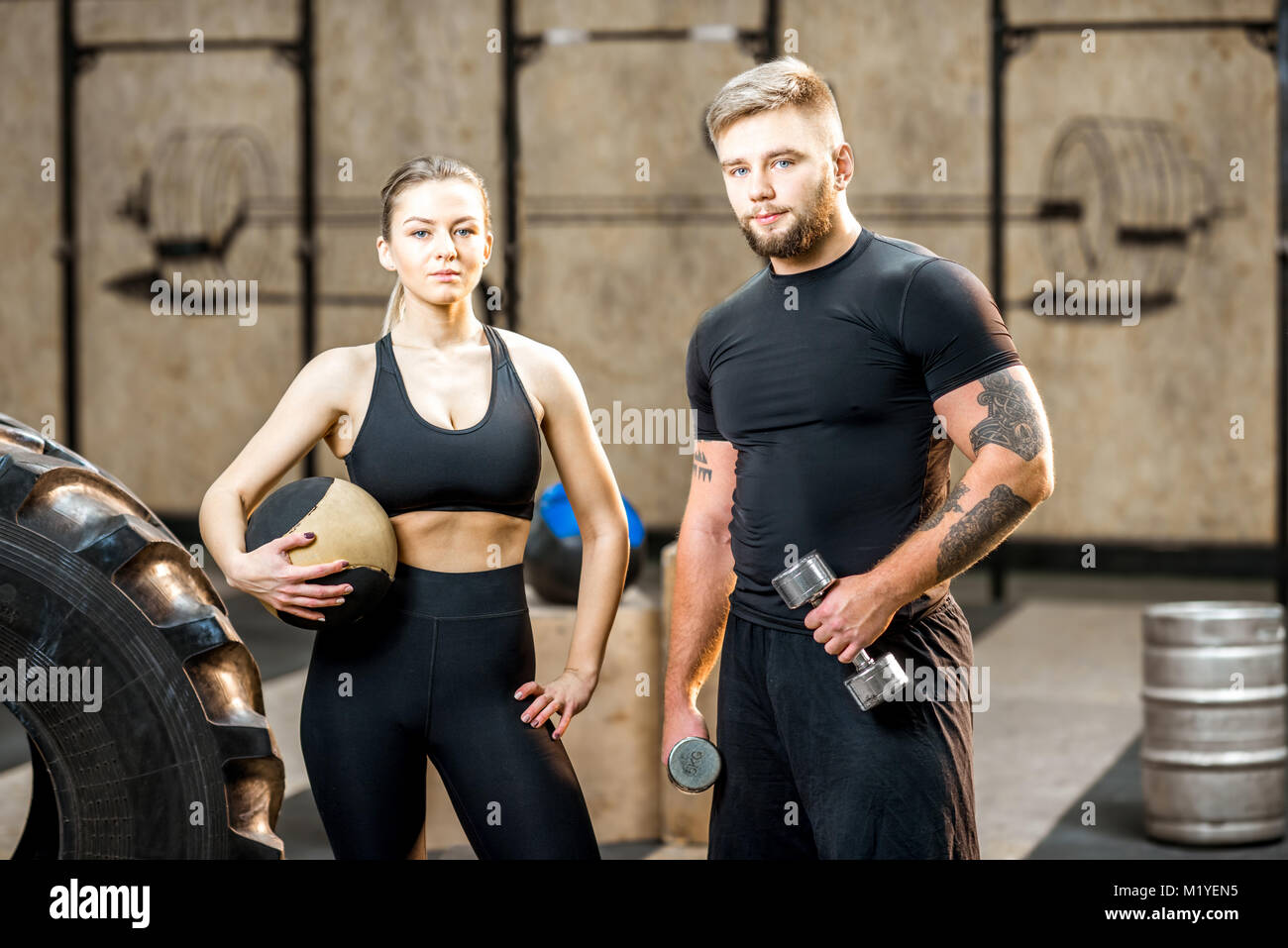 Young couple in the gym during the break Stock Photo - Alamy