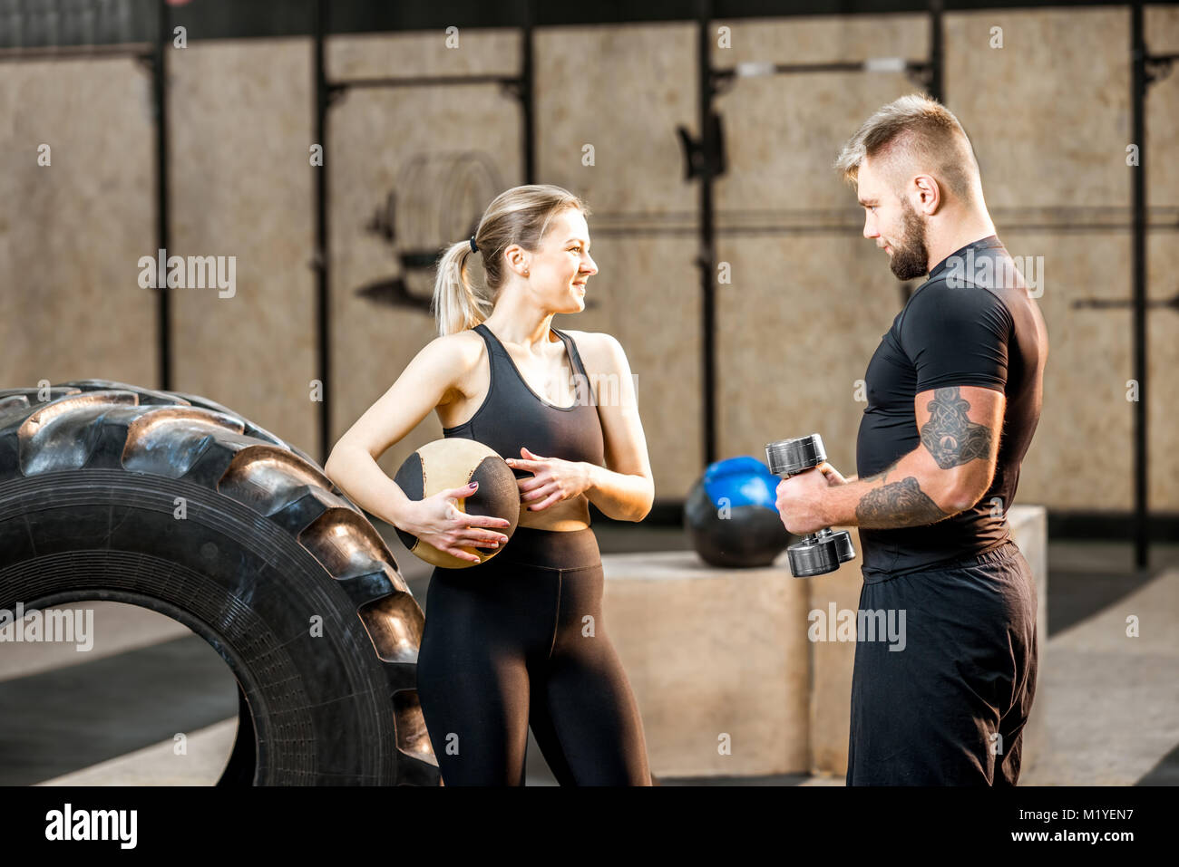 Young couple in the gym during the break Stock Photo - Alamy