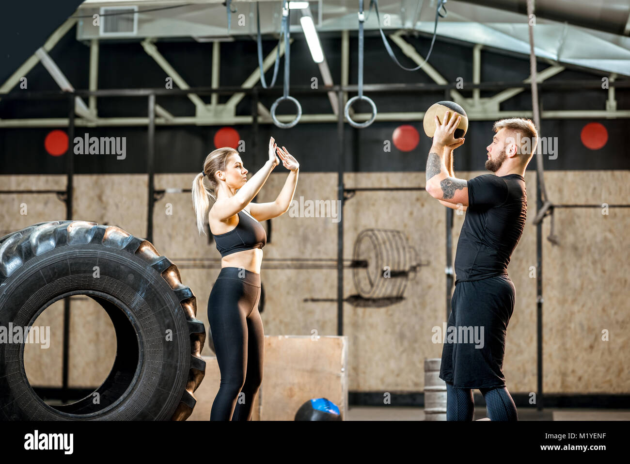 Young couple training with ball in the gym Stock Photo - Alamy