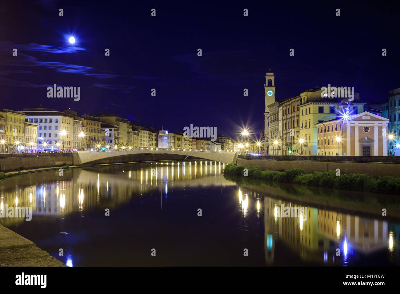 Florence, Tuscany, Italy. Noctunal view to bridges across Arno river with an old church in foreground. Stock Photo