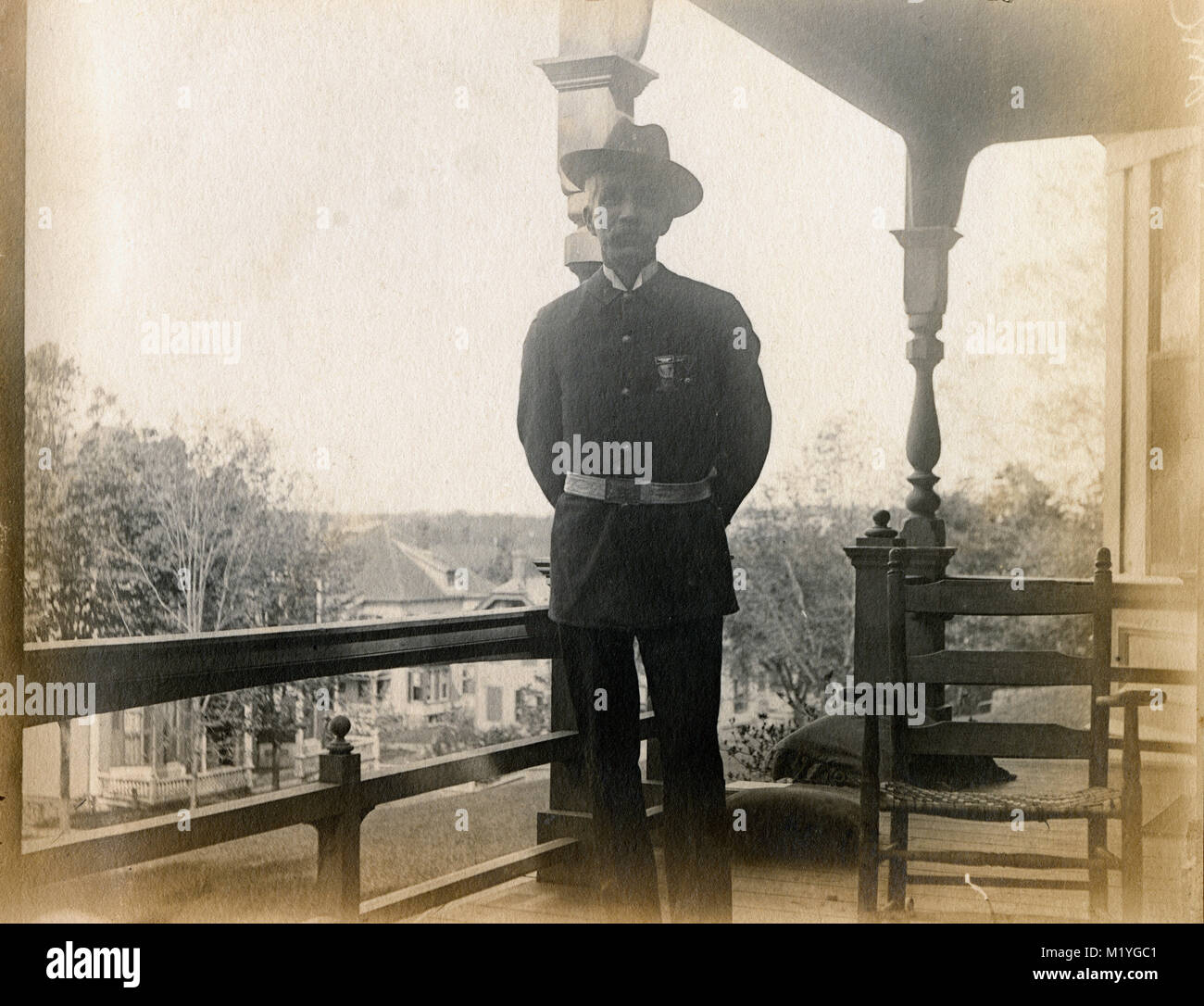 Antique circa 1905 photograph, elderly gentleman on his porch in military uniform with GAR badges. Location unknown, probably New England, USA. I have more photos of this family in Riggsville (now Robinhood), Maine in Sagadahoc County, USA. Stock Photo