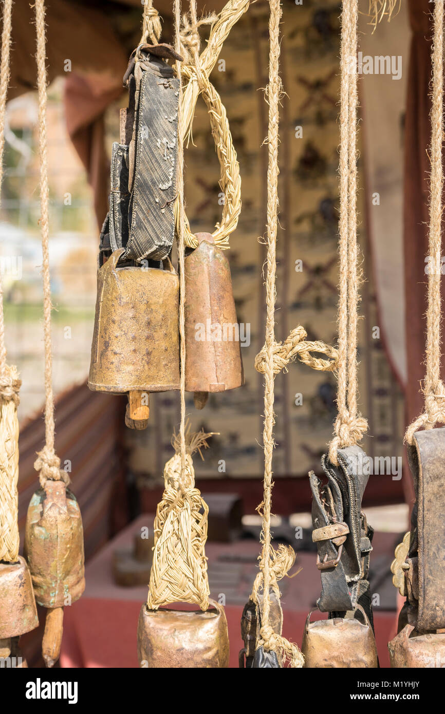 metal and brass cowbells hanging in a medieval stall Stock Photo Alamy