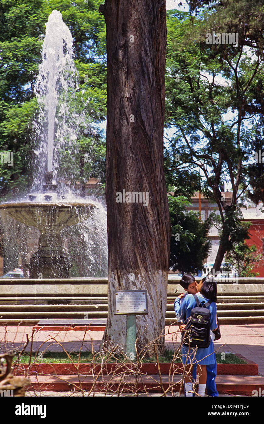 students kissing in park Oaxaca Mexico Stock Photo