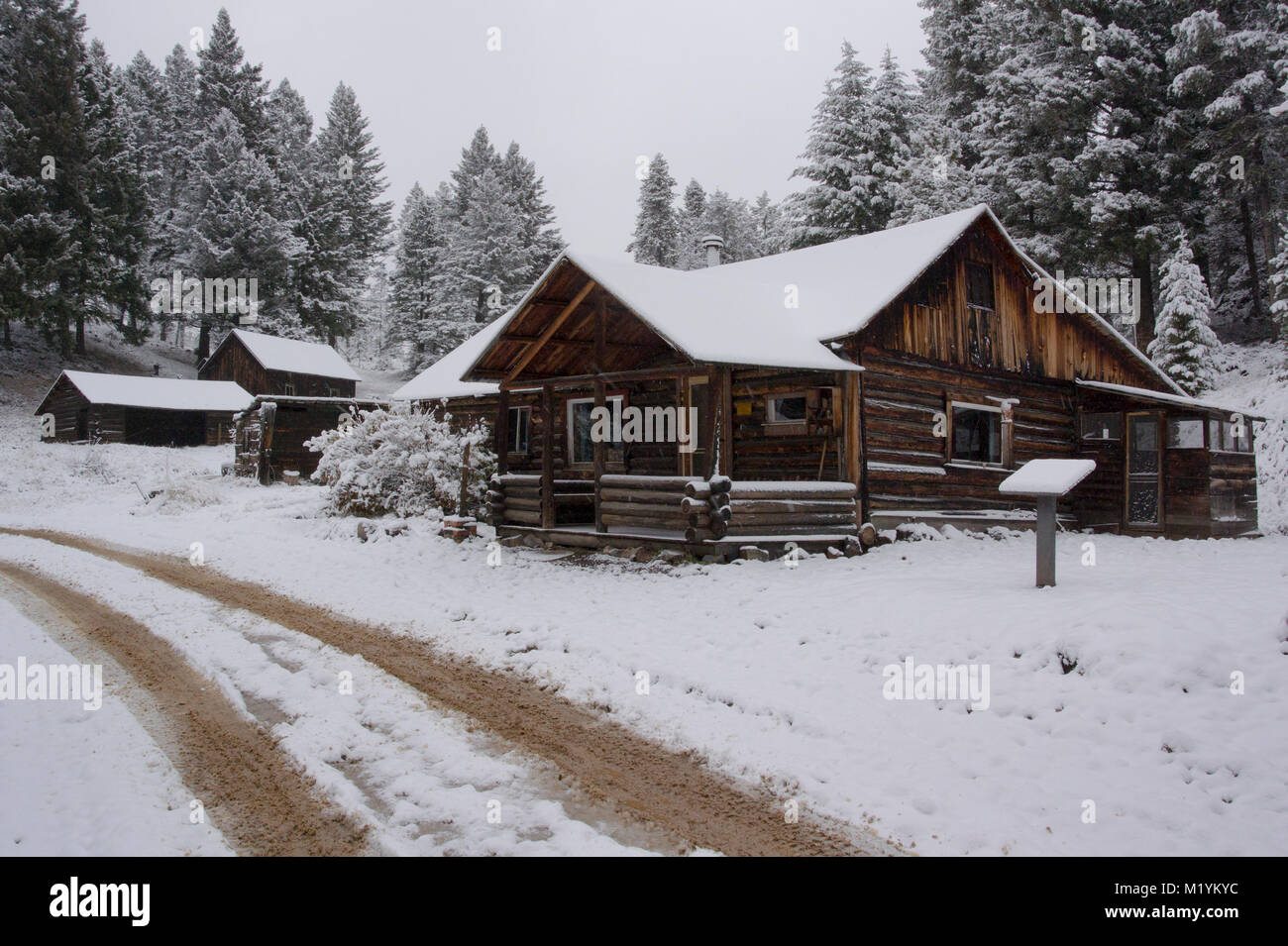 Snow covered wooden cabins at the Ghost Town, on Bear Gulch