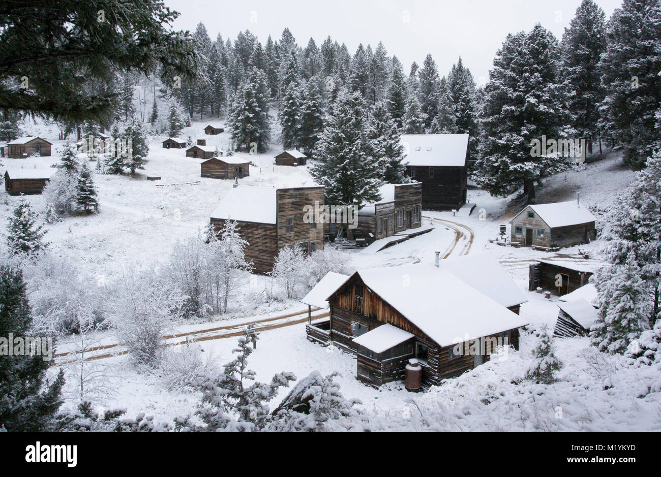 Snow covered wooden cabins at the Ghost Town, on Bear Gulch
