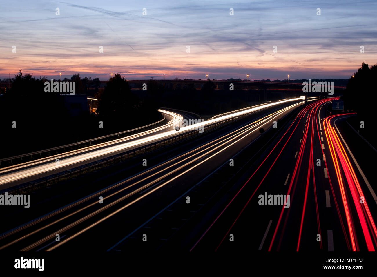 German Autobahn with light trails at night Stock Photo