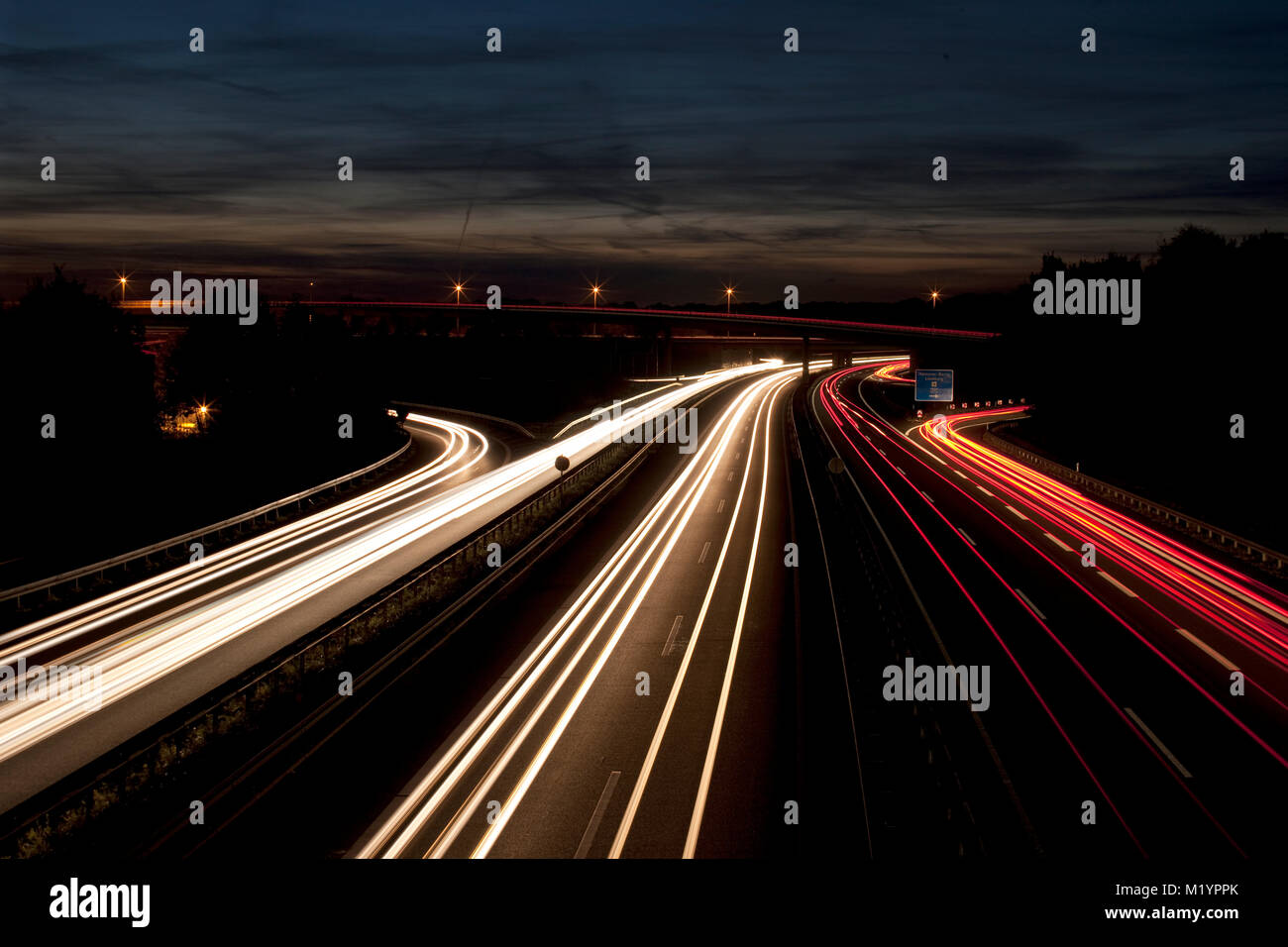 German Autobahn with light trails at night Stock Photo