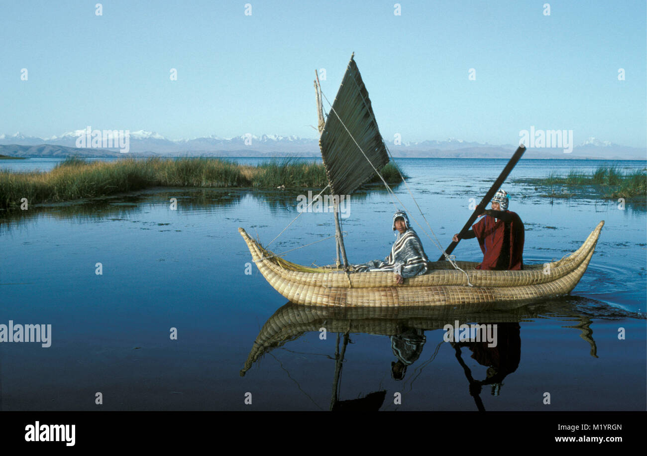 Bolivia. Copacabana. Titicaca lake. Andes mountains. Aymara indian fisherman in reed sailing boat. Stock Photo