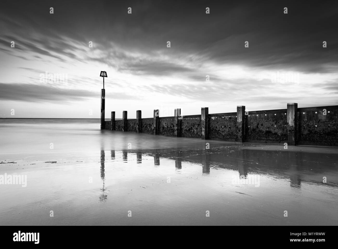 Surfer in the ocean at sunrise Black and White Stock Photos & Images ...