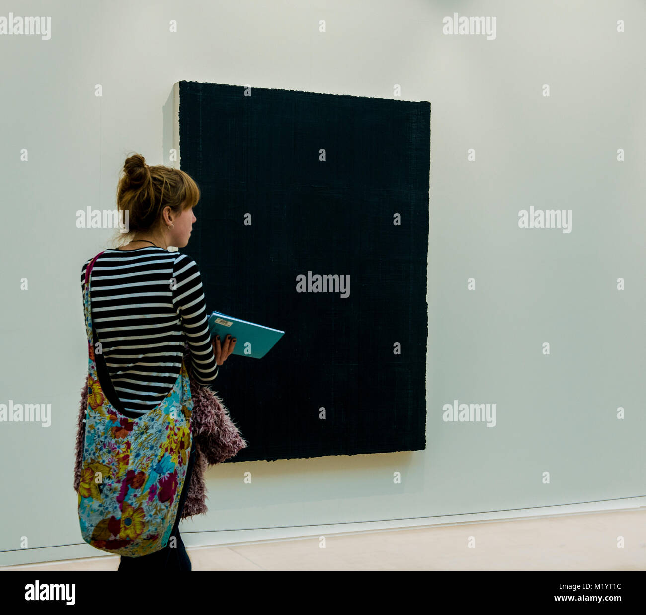 Woman in front of modern artwork, Leeds Modern Art Gallery, Leeds, England Stock Photo