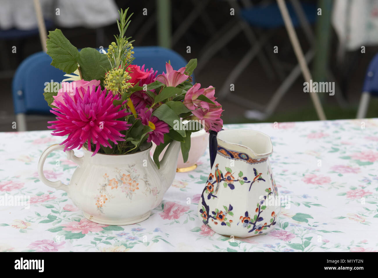 teapot full of spring flowers on a table Stock Photo - Alamy
