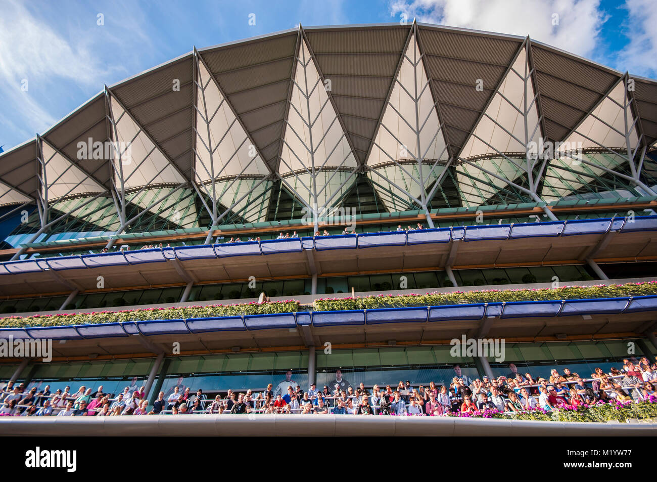 Crowds at Royal Ascot racecourse with grandstand. Space for copy Stock Photo