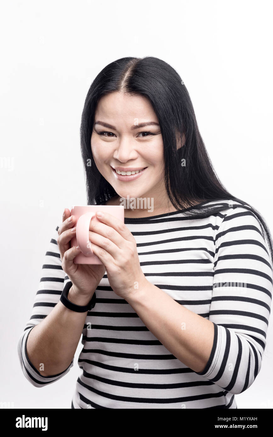 Adorable woman cupping her coffee cup in her hands Stock Photo Alamy