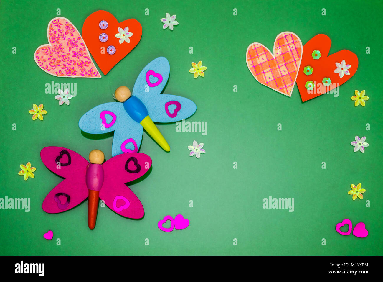Greeting card with hearts and dragonflies on colored background Stock Photo