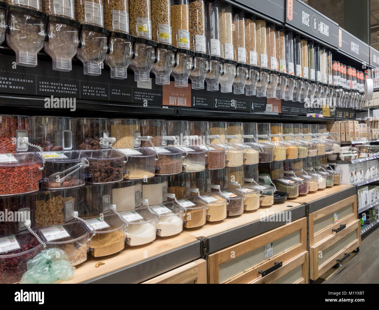 Bulk bins containing Rice, grains, flours, pasta, soup mixes, beans, cereals, dried fruits, nuts & seeds in Whole Foods Market store, Arlington, USA. Stock Photo