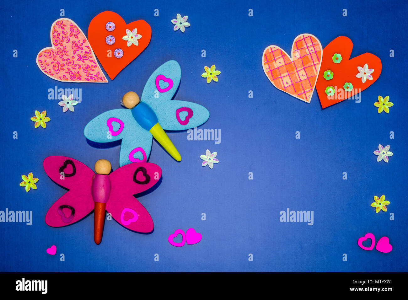 Greeting card with hearts and dragonflies on colored background Stock Photo