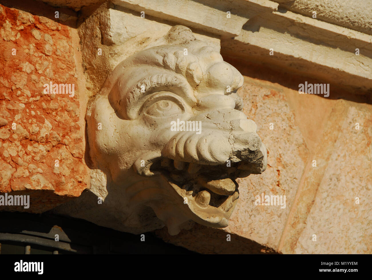 Monstrous dragon or crocodile head old relief from Saint Margherita closed chruch belfry in Venice (17th century) Stock Photo