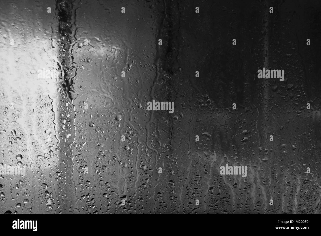 glass window pane with rain and condensation drops Stock Photo