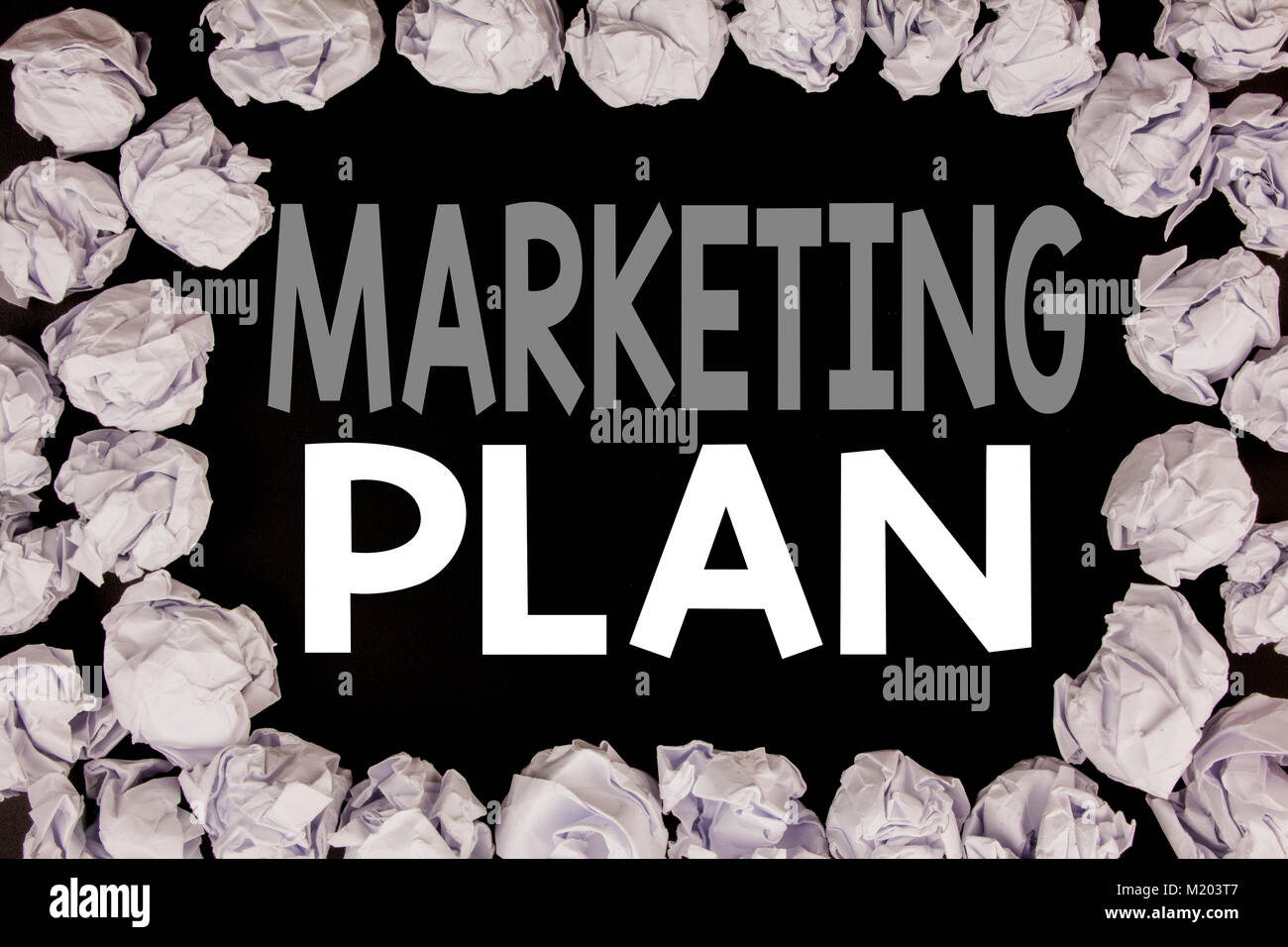 Word, writing Marketing Plan. Business concept for Planning Successful Strategy written on black background with copy space on background with folded  Stock Photo