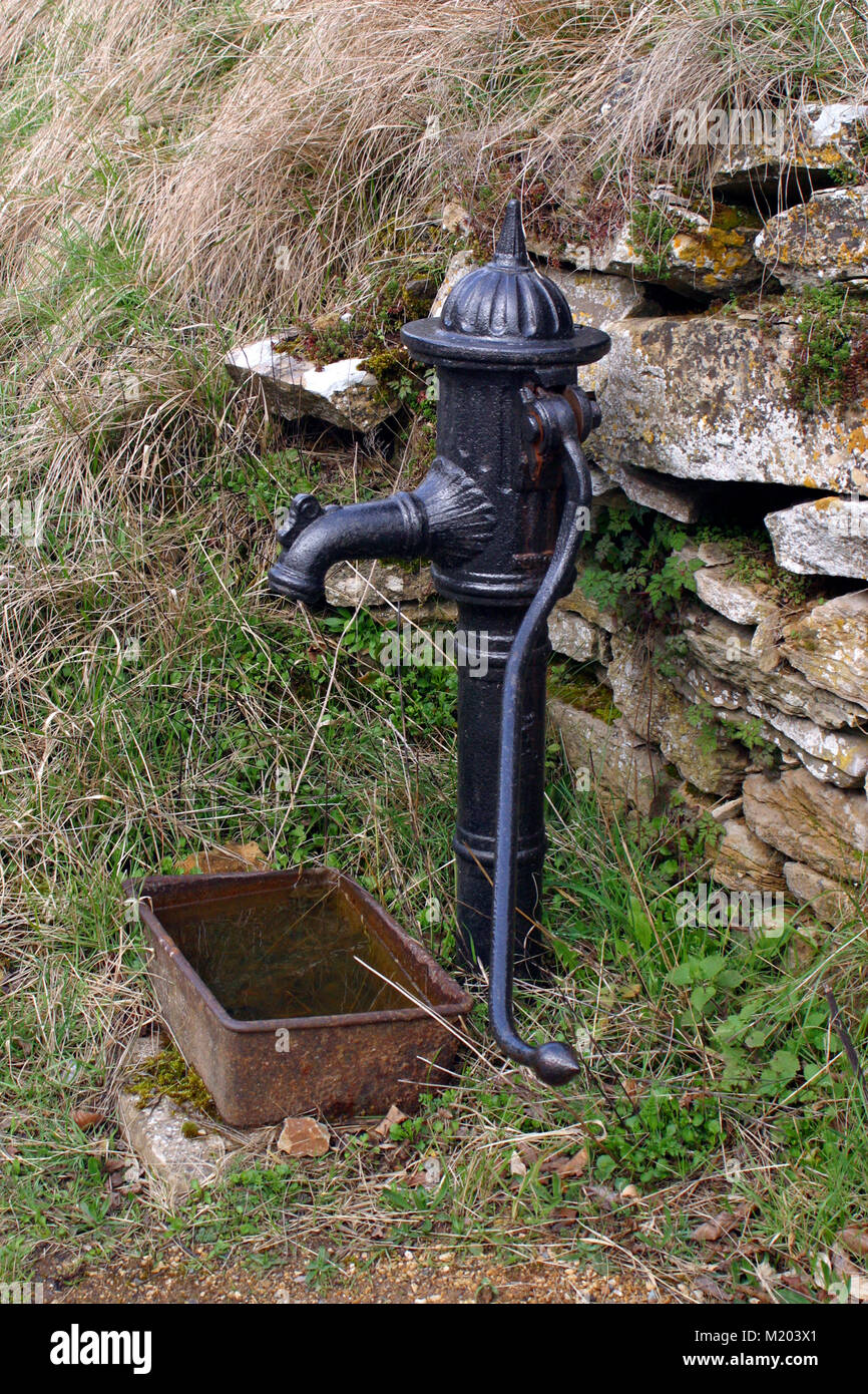 An old village water hand pump, Cotswolds, Gloucestershire, England, UK Stock Photo