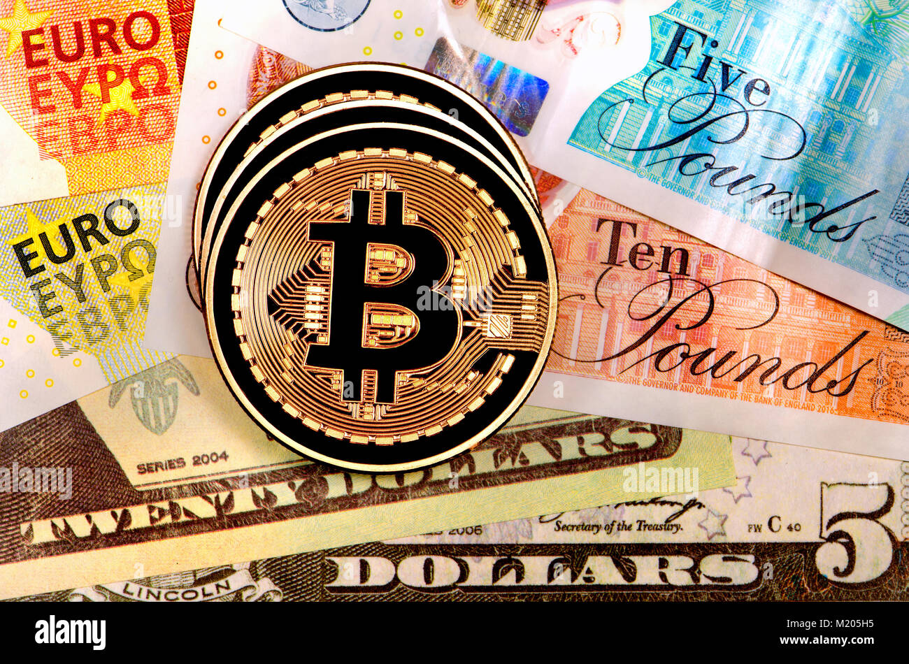 Bitcoin cryptocurrency / payment system (Copper Bitcoin Commemorative Round .999 bullion) Electronic currency with Dollars Pounds and Euros. Digitaly  Stock Photo