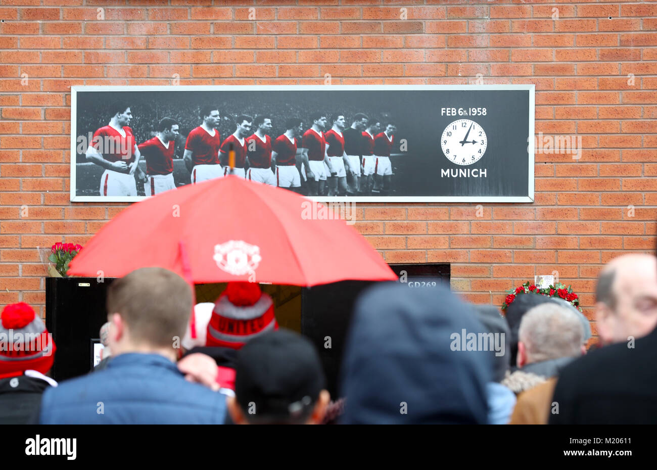 Fans look at a tribute to the Munich air disaster ahead of the Premier League match at Old Trafford, Manchester. Stock Photo