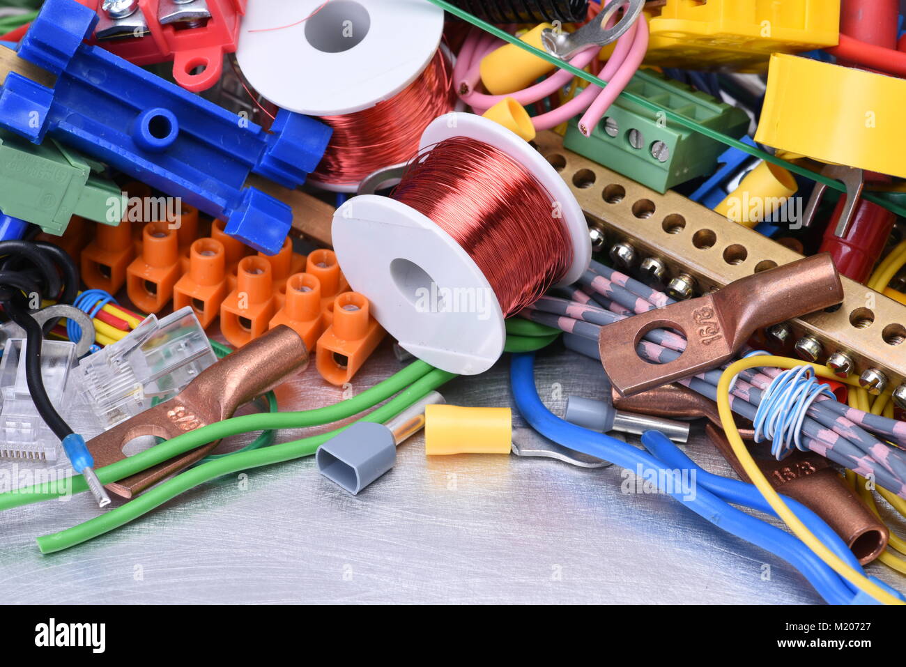Components and accessories for use in electrical installations on metal