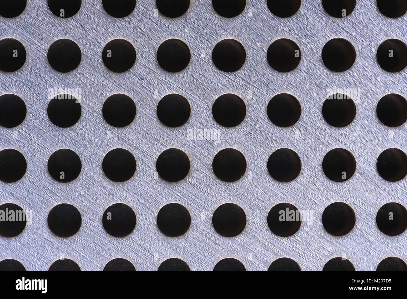 Close up of metal background texture with holes Stock Photo