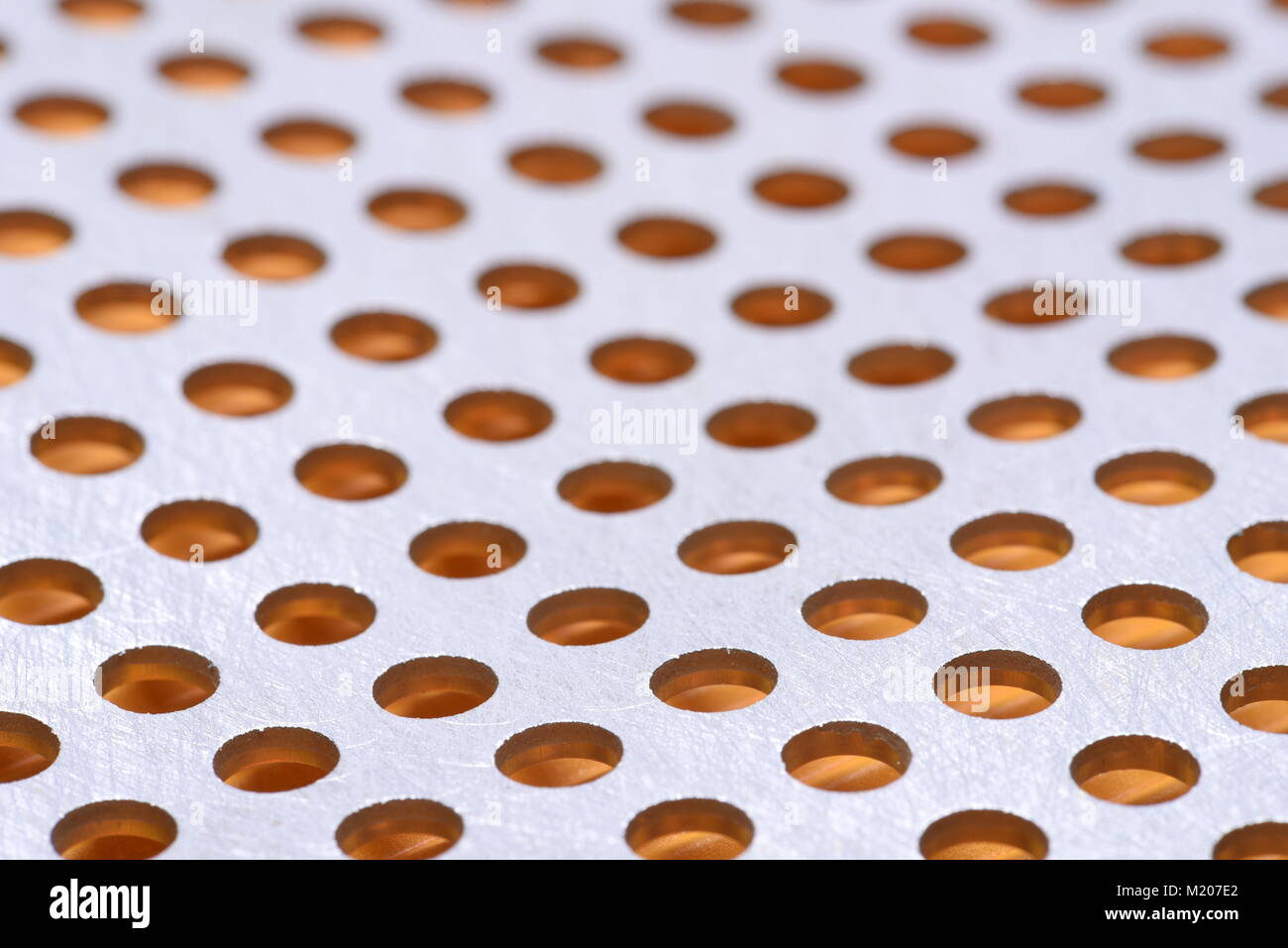 Abstract background of metal surface with holes Stock Photo