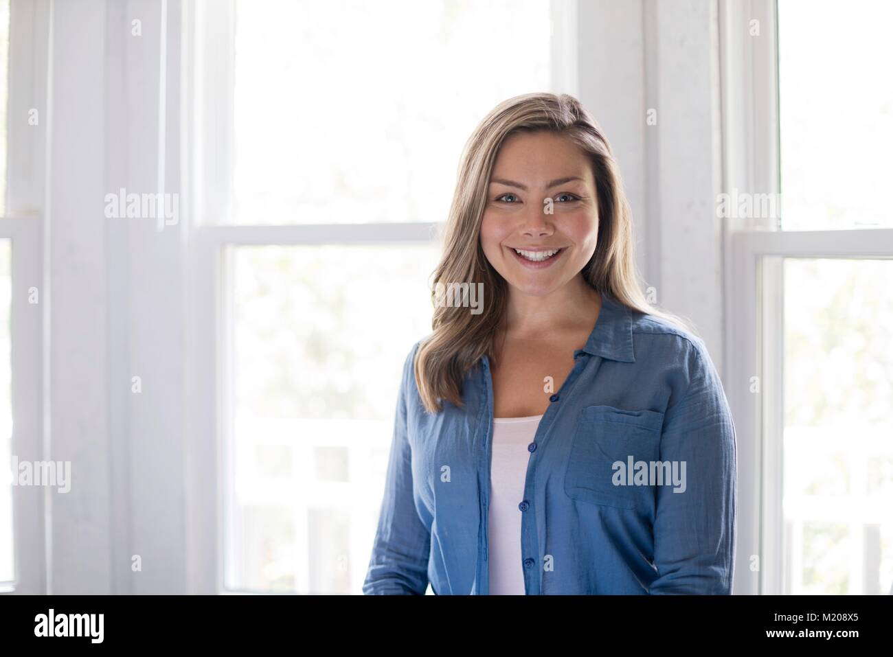 Portrait of young woman smiling towards camera. Stock Photo