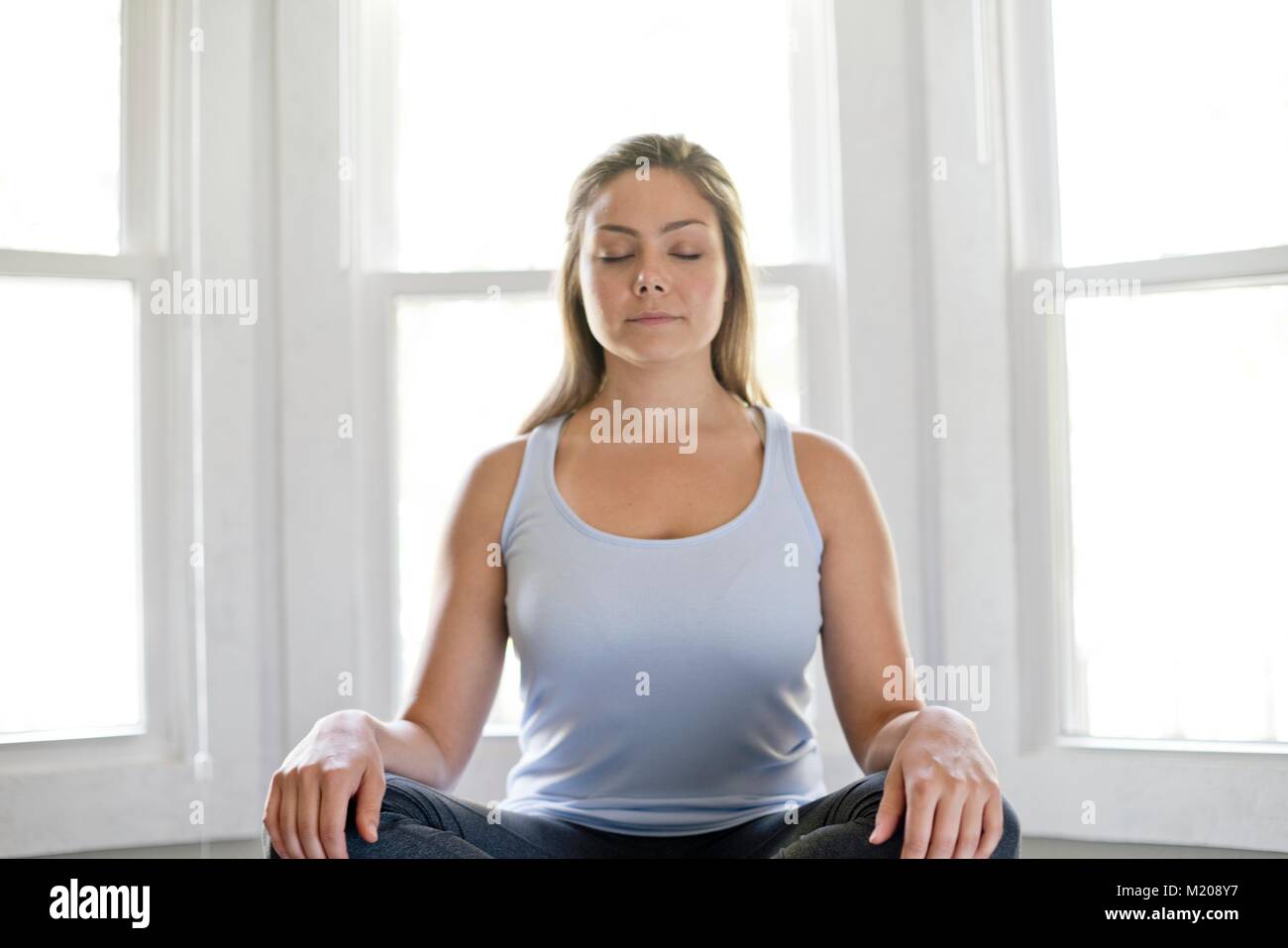 Portrait of young woman meditating. Stock Photo