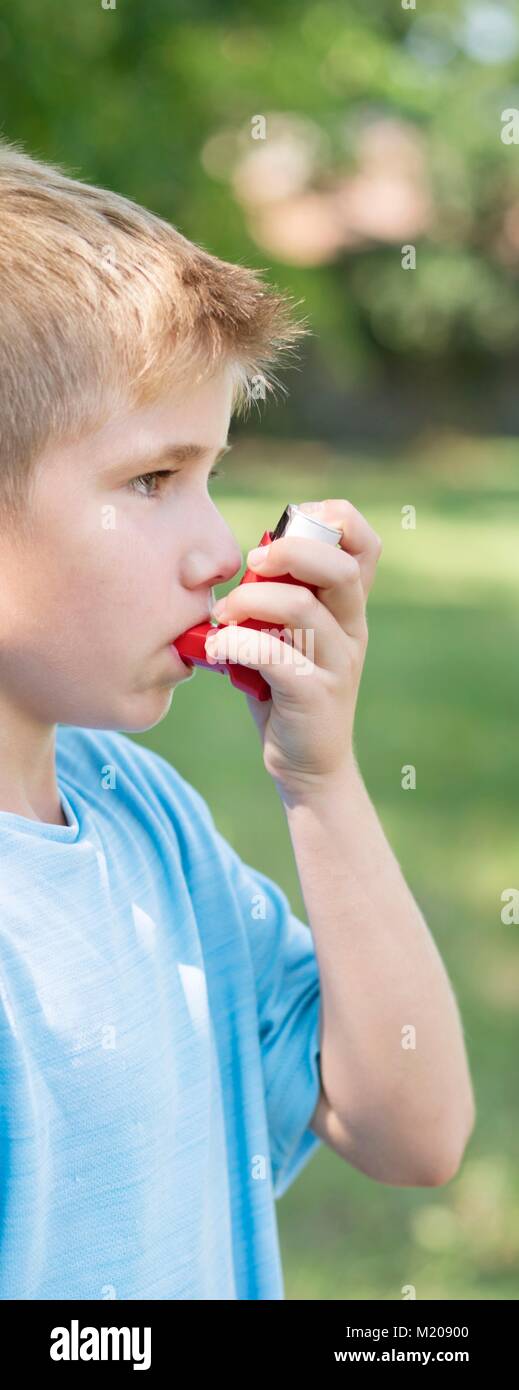 Young boy using an inhaler. Stock Photo