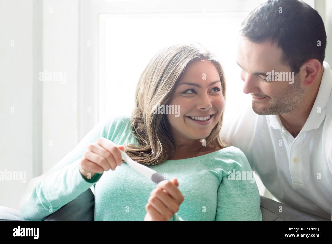 Couple looking at pregnancy test. Stock Photo