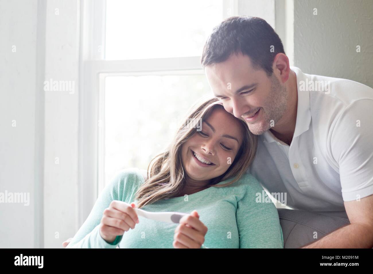 Couple looking at pregnancy test. Stock Photo