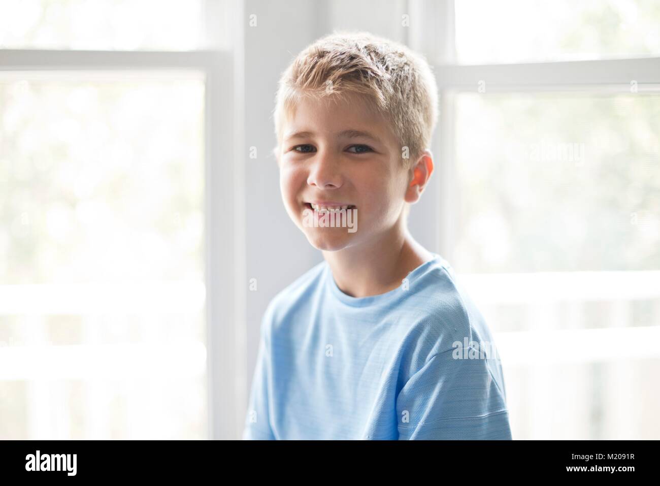 Portrait of a young boy smiling towards the camera. Stock Photo