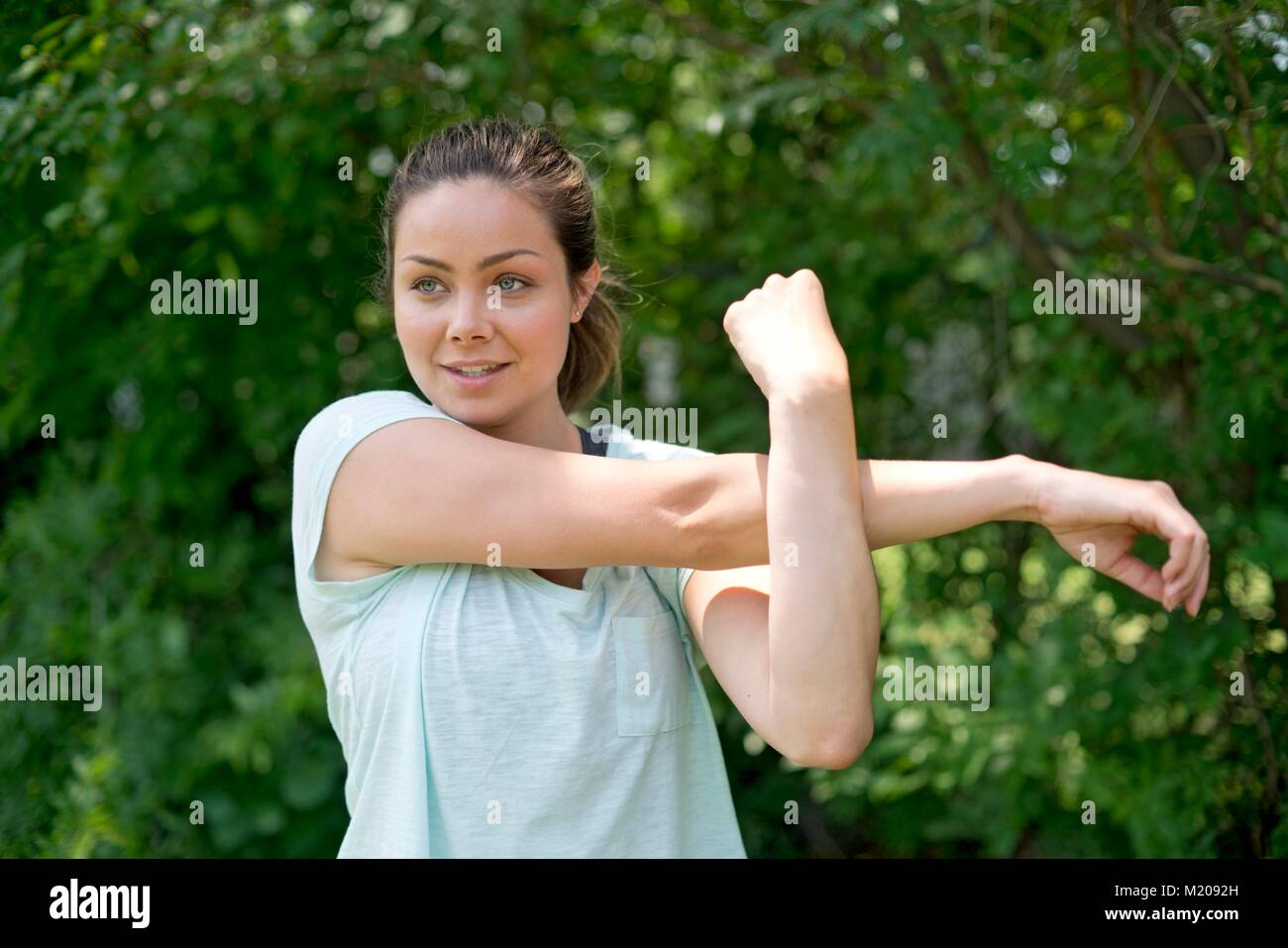 Young woman stretching before exercise. Stock Photo