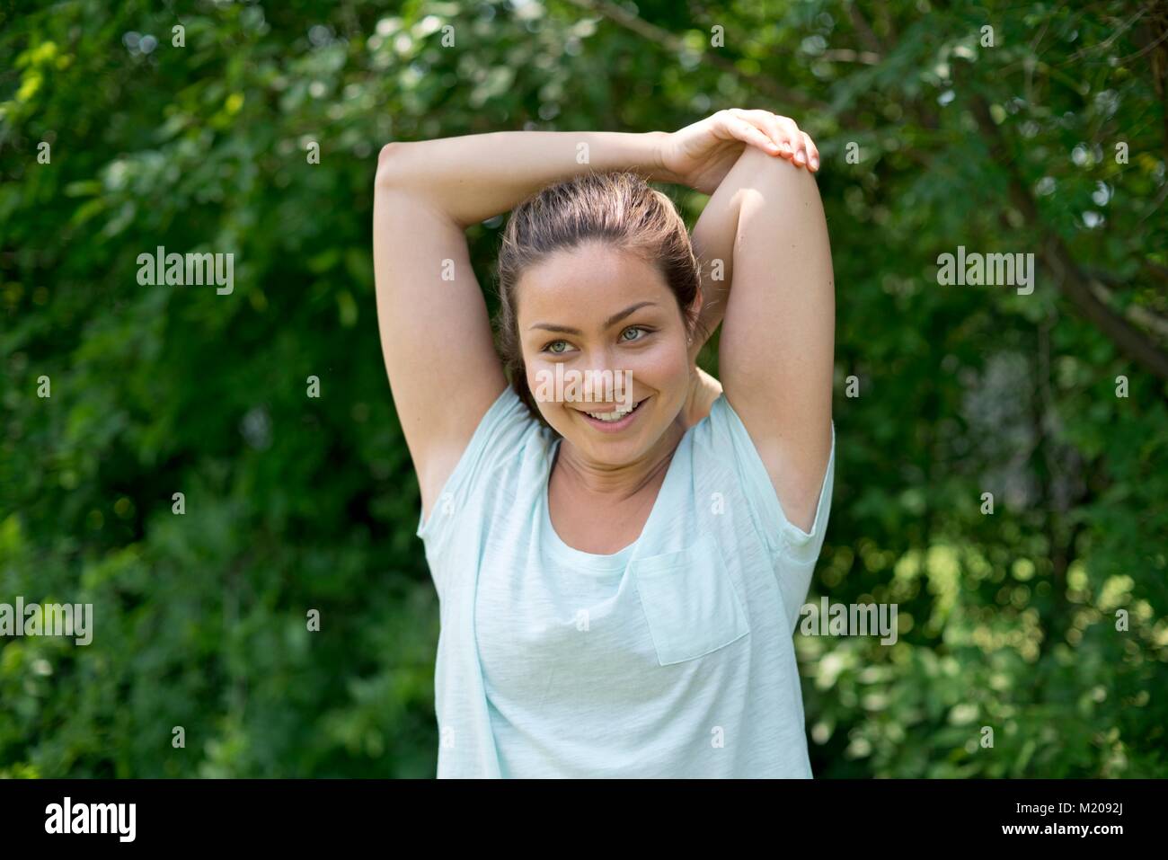 Young woman stretching before exercise. Stock Photo
