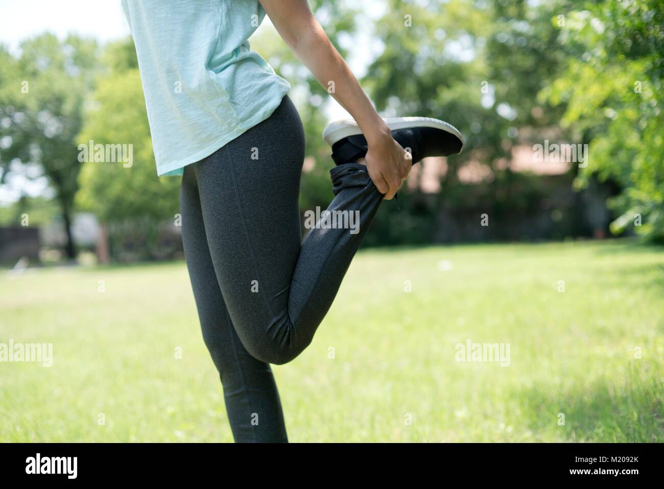 Woman stretching quads. Stock Photo