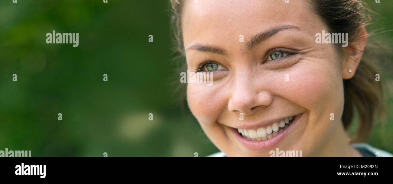 Young woman smiling and looking away. Stock Photo
