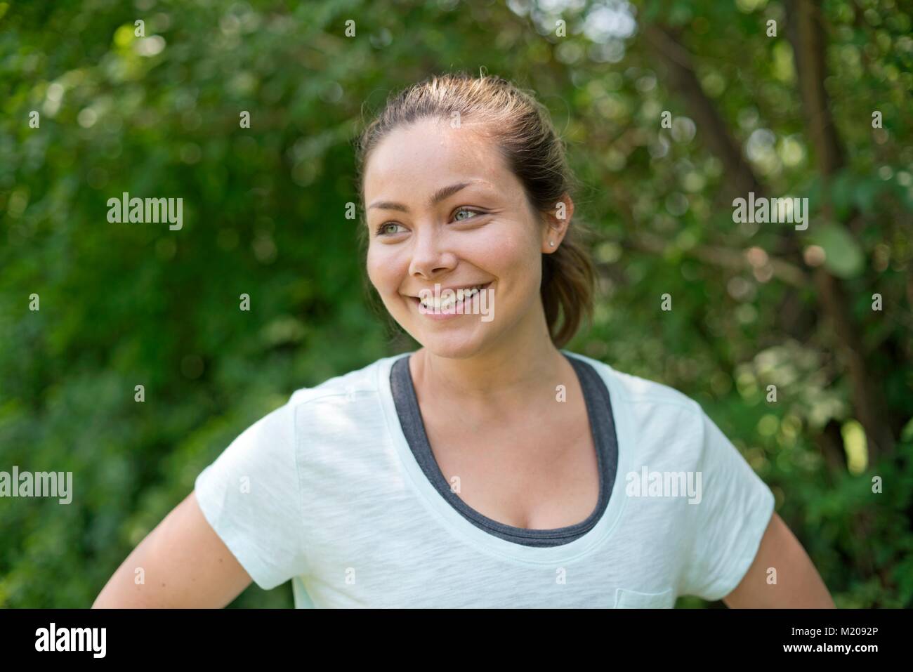 Young woman smiling and looking away. Stock Photo