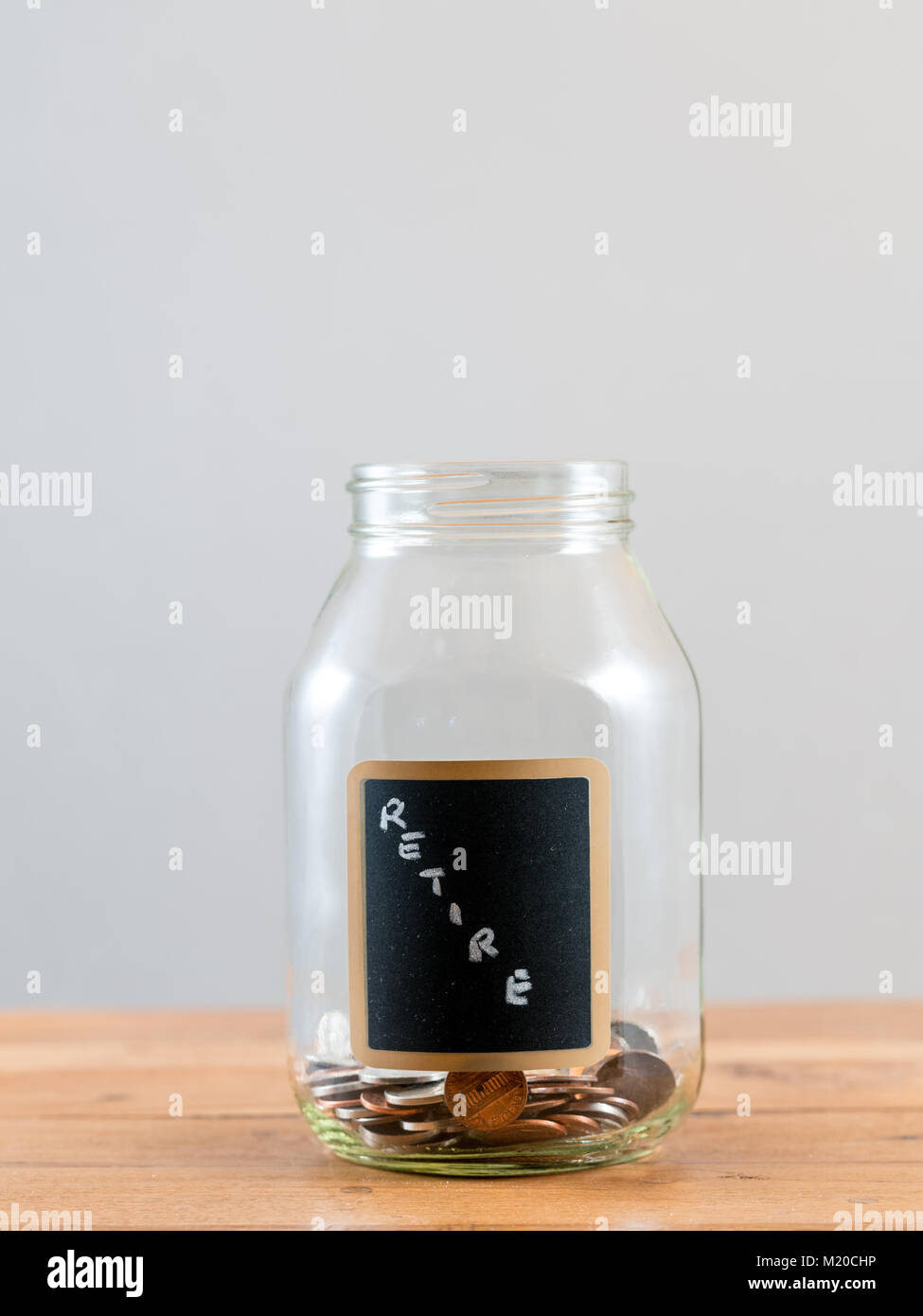 Loose change inside glass jar to represent retirement savings   Stock Photo