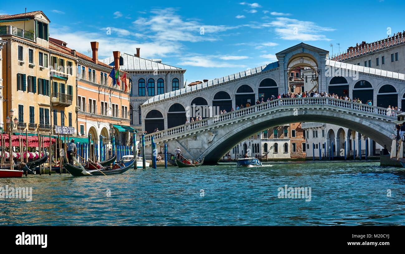 VENICE, ITALY - MAY 21, 2017: Beautiful view of old buildings, gondolas and the Rialto Bridge from a gondola at the Grand Canal in Venice, Italy. Stock Photo
