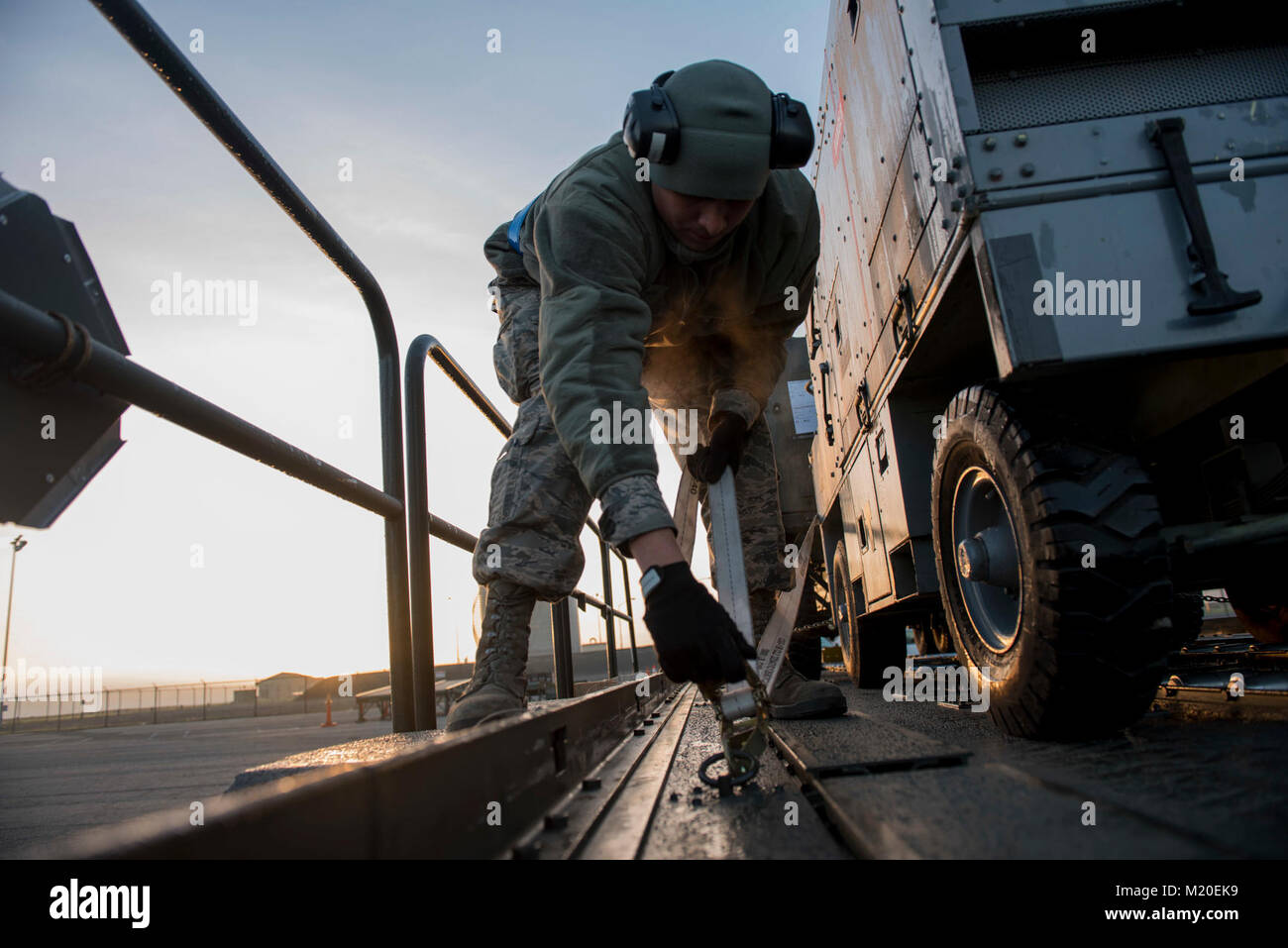 Airman Jim Puentes, 60th Aerial Port Squadron ramp operator, tightens ...