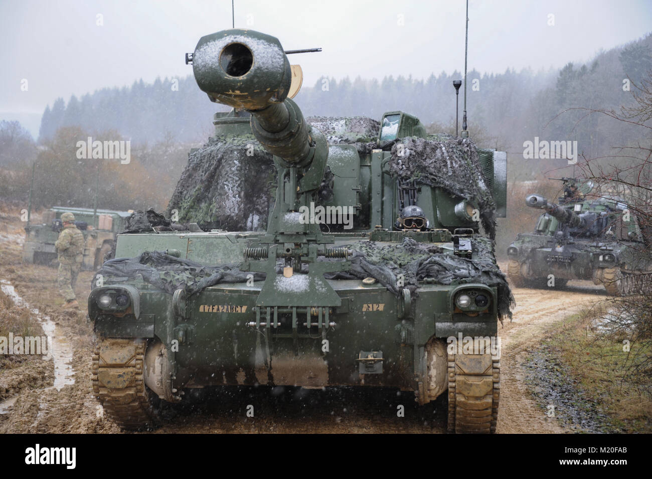 U.S. Soldiers with Battery A, 1st Battalion, 7th Field Artillery Regiment, 2nd Armored Brigade Combat Team, 1st Infantry Division, maneuver a M109A6 Paladin howitzer in preparation for a live fire exercise at the 7th Army Training Command's Grafenwoehr Training Area, Feb. 01, 2018. The rotational deployments of armored brigade combat teams are a tangible expression of U.S. commitment to strengthening the defensive and deterrent capabilities of the NATO alliance.  (U.S. Army photo by Markus Rauchenberger) Stock Photo