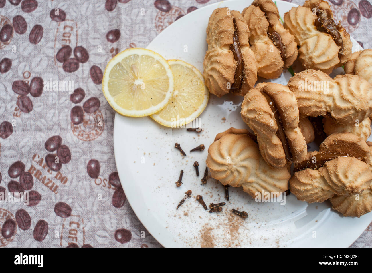 cookies on a plate with condensed milk with lemons under a coffee Stock