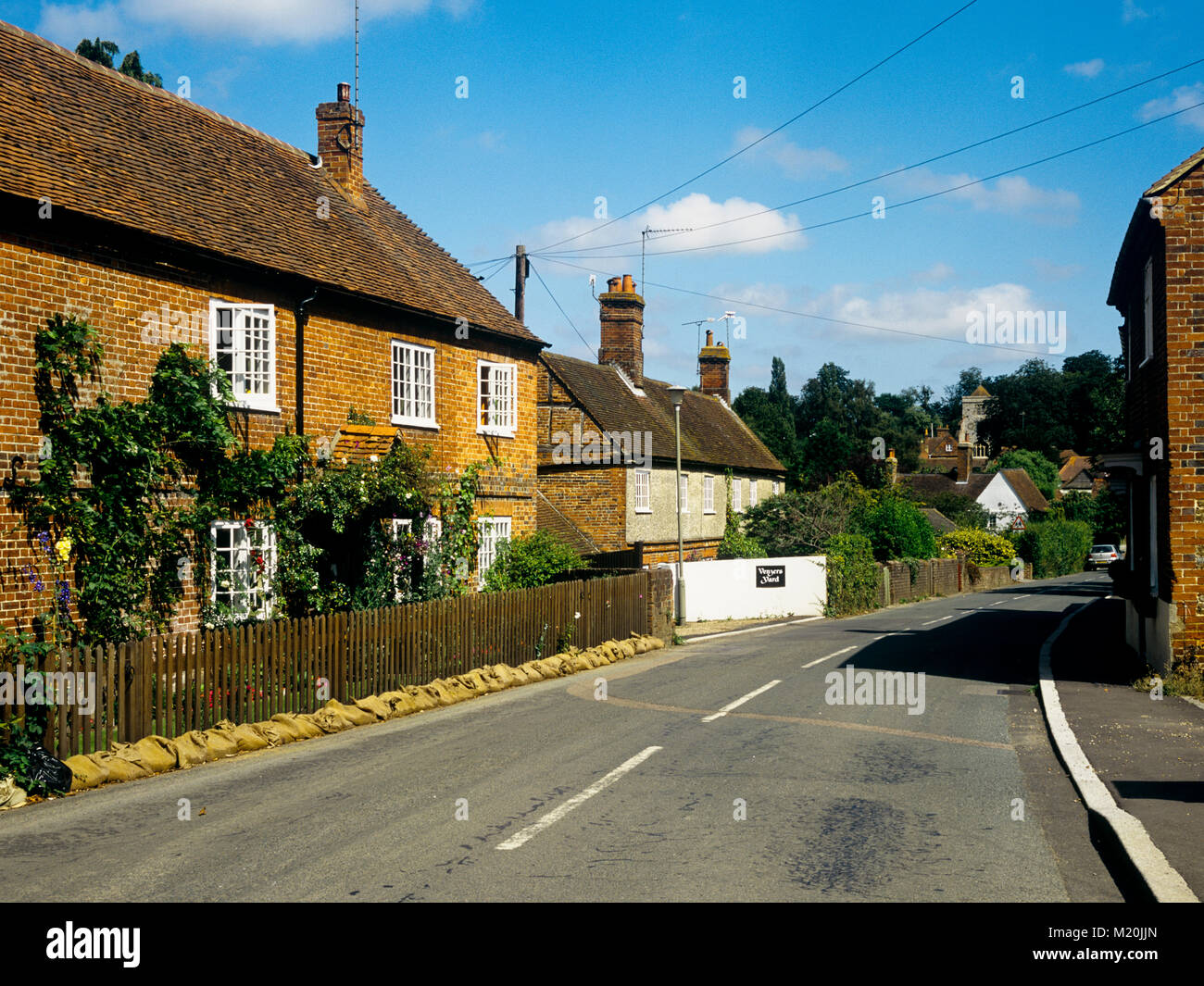 View down main street of attractive village Puttenham Surrey England UK Stock Photo