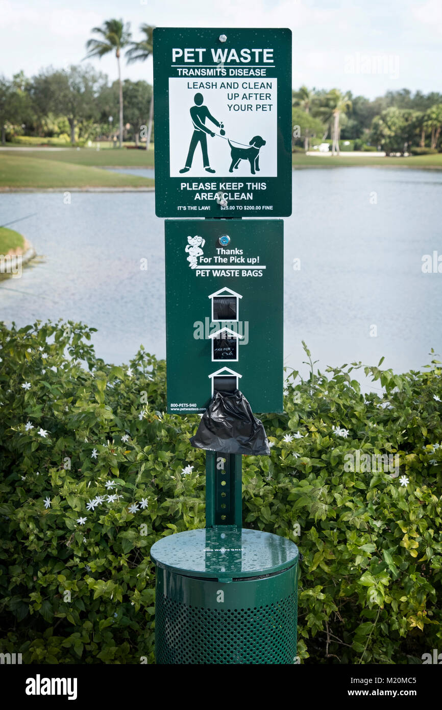 A dispenser giving out free pet waste bags to clean after dogs and a