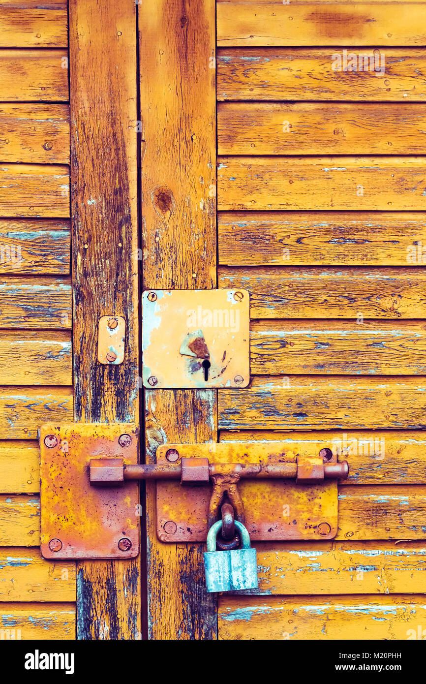 Old background texture with a rusty lock on the door Stock Photo - Alamy